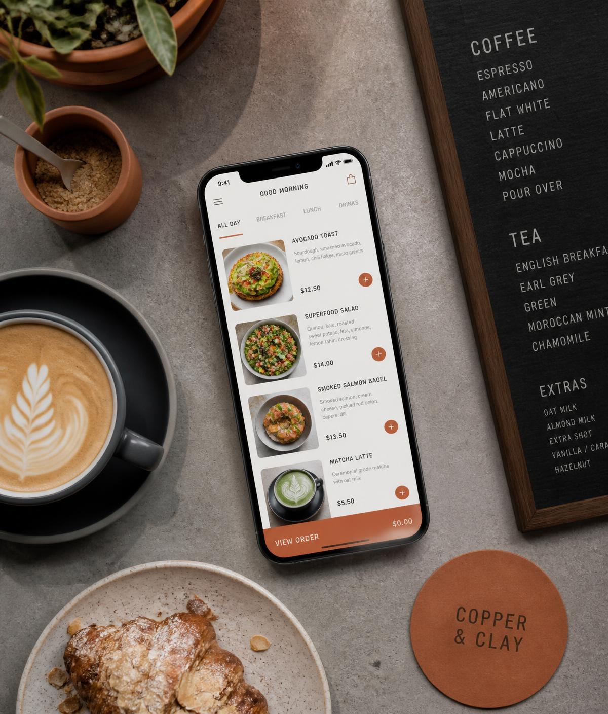 Phone showing a café's mobile ordering menu on a counter